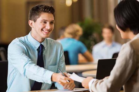 Young smiling man interviewing with employer