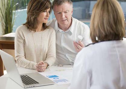 mature couple consulting with doctor about medicine