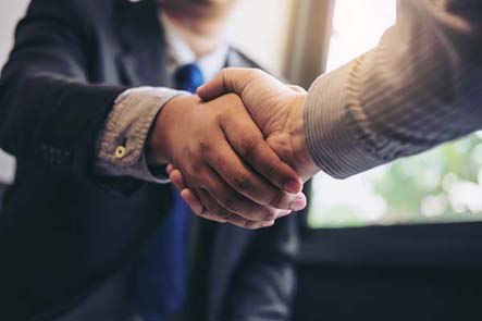 business people shaking hands to form a partnership