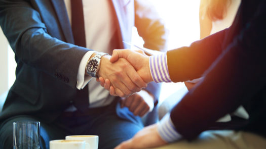 business partners shake hands on an agreement